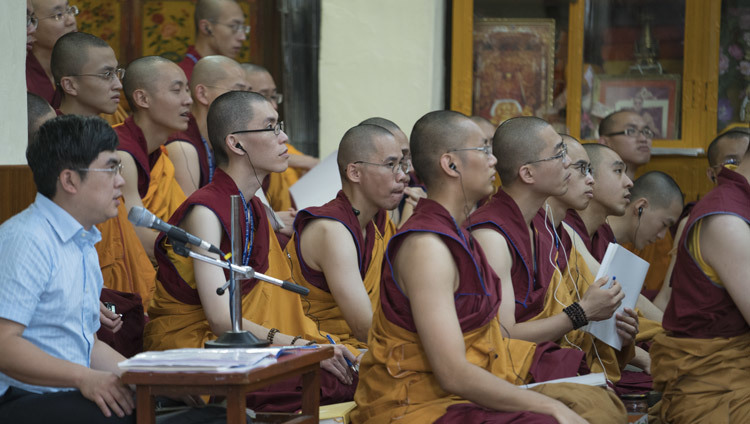 Members of the audience standing in the doorway of the Main Tibetan Temple to catch a glimpse of His Holiness the Dalai Lama during a break in his teachings in Dharamsala, HP, India on October 4, 2016. Photo/Tenzin Choejor/OHHDL