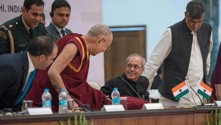 His Holiness the Dalai Lama talking to President of India Pranab Mukherjee as he takes his seat at the start of the Laureates and Leaders for Children Summit in New Delhi, India on December 10, 2016. Photo/Tenzin Choejor/OHHDL