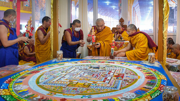 His Holiness the Dalai Lama looks on as Thamthog Rinpoche placing ritual implements around the completed Kalachakra sand mandala during preparations for the Kalachakra Empowerment in Bodhgaya, Bihar, India on January 8, 2017. Photo/Tenzin Choejor/OHHDL