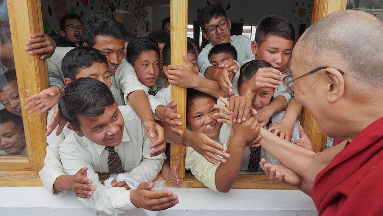 Students reaching out to His Holiness the Dalai Lama as he departs from Ladakh Public School in Leh, Ladakh, J&K, India on July 8, 2017. Photo by Jeremy Russell/OHHDL