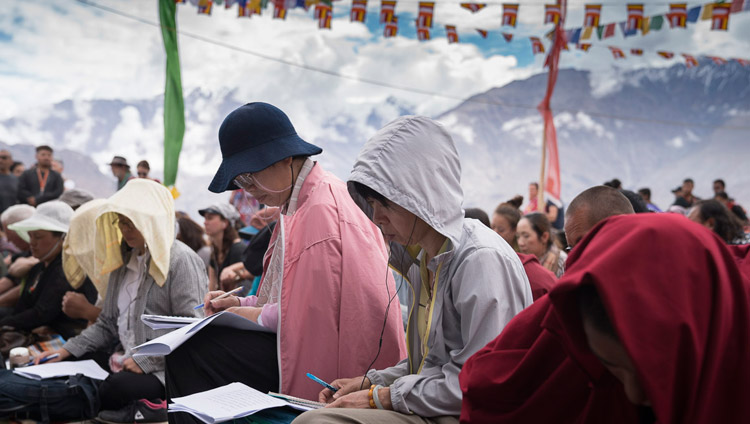 Members of the audience following the text as His Holiness the Dalai Lama continues his teaching on ‘Thirty-seven Practices’ in Disket, Nubra Valley, J&K, India on July 13, 2017. Photo by Tenzin Choejor/OHHDL