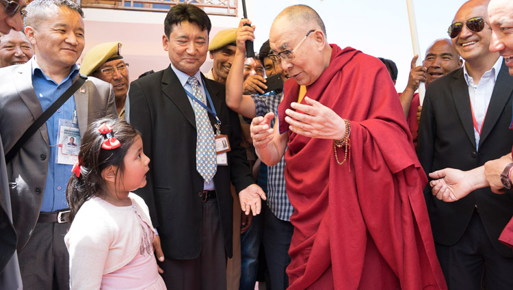 His Holiness the Dalai Lama is charmed by a young girl asking serious questions as he departs from Matho Phodrang in Leh, Ladakh, J&K, India on July 20, 2017. Photo by Tenzin Choejor/OHHDL