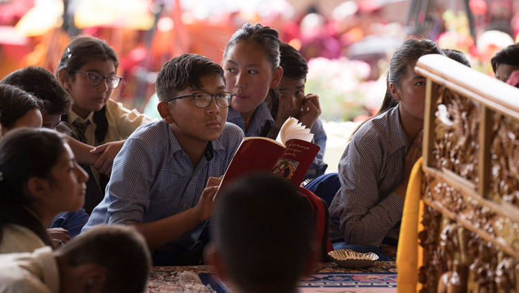 Students sitting at the feet of His Holiness the Dalai Lama after he asked them to come sit in front of him out of the sun on the final day of his teachings in Leh, Ladakh, J&K, India on July 30, 2017. Photo by Tenzin Choejor/OHHDL