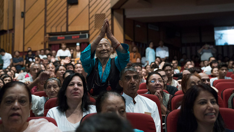 An elderly Tibetan paying respects to His Holiness the Dalai Lama as he addresses the Tibetans in the audience after his talk at the Siri Fort Auditorium in New Delhi, India on August 10, 2017. Photo by Tenzin Choejor/OHHDL