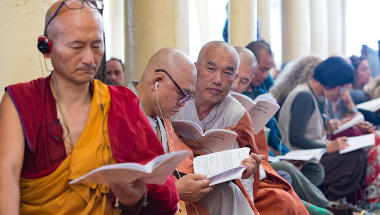 Members of the audience form SE Asia following the text during His Holiness the Dalai Lama's third day of teachings at the Tsuglagkhang in Dharamsala, HP, India on August 31, 2017. Photo by Tenzin Choejor/OHHDL