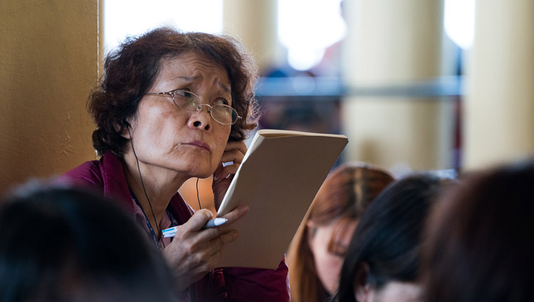 A member of the audience listening to the FM translation of His Holiness the Dalai Lama on the third day of his teachings requested by Taiwanese Buddhists at the Tsuglagkhang in Dharamsala, HP, India on October 5, 2017. Photo by Tenzin Choejor