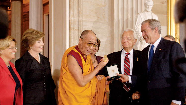 His Holiness the Dalai Lama receiving the US Congressional Gold Medal from US President George W. Bush at Capitol Hill in Washington DC, USA on October 17, 2007.